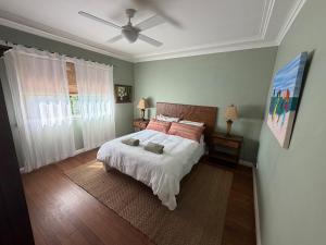 a bedroom with a bed and a ceiling fan at Hoop Lodge in Bellingen