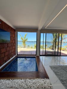 a house with a swimming pool with a view of the beach at Koko Beach - Honeymoon Suite in Vila Praia Do Bilene