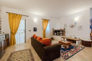 a living room with a couch and a table at Villa NiLo Natura - Rustic Mountain Charm in Telti