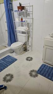 a bathroom with a toilet on the floor at Smithy's Apartment 2 in Ribishi