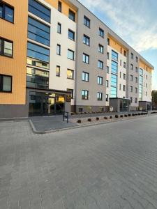 a large building with a street in front of it at Apartament Bursztynowy Lębork in Lębork
