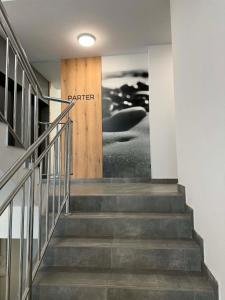 a stairway with a wooden door with the words partner at Apartament Bursztynowy Lębork in Lębork