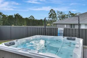 a hot tub on the back of a backyard at Hunter Hideaway in Cessnock