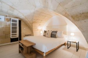 a bedroom with a bed with an arch ceiling at Corte Dei Saraceni - Lecce Selection in Lecce +79 photos
