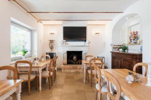 a dining room with wooden tables and a fireplace at Borgo Cozzana in Monopoli