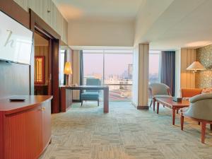 a hotel room with a view of a living room at Horison Ultima Menteng Jakarta in Jakarta