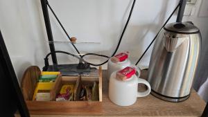 a table with two coffee mugs and a coffee pot at Sunshine cottage in Clontarf