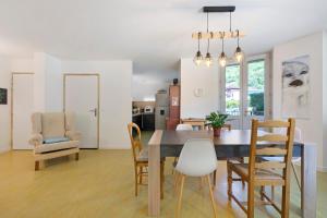 a kitchen and dining room with a table and chairs at L'auberge le Toit Vert in Moutiers