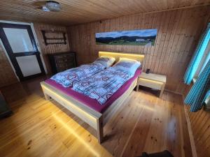 a bedroom with a bed in a wooden room at Zum fröhlichen Eichhörnchen in Feldberg