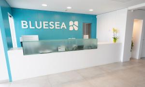 a bluesea office with a sign on the wall at BLUESEA Playa Azul in Cala en Porter