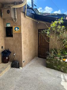 a building with a door and a plant on the side at 緩寓 Sora Apt包棟民宿2-8人 in Jiufen