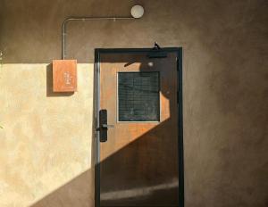 a shower with a glass door with a window at 緩寓 Sora Apt包棟民宿2-8人 in Jiufen