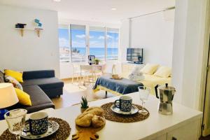 a living room with a couch and a table at Capri 403 in Torrox Costa