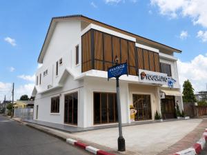 a white building on the side of a street at MinimalYala in Yala