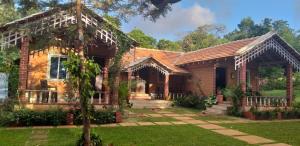 a home with a brick house at Lovelynest homestay in Attigundi