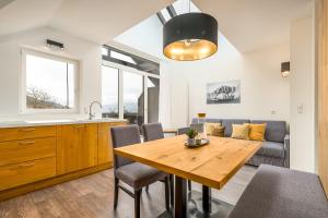 a kitchen and dining room with a wooden table and chairs at Bergheim Plose - Appartements in St Andrä bei Brixen in Bressanone