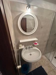 a bathroom with a sink and a mirror at Villa Elisabetta in Malcesine