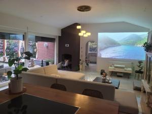 a living room with a large painting on the wall at Natur Spa Haus in Niederkrüchten