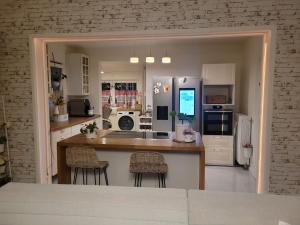 a kitchen with a counter and some chairs in it at Natur Spa Haus in Niederkrüchten +15 photos