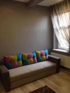 a couch with a colorful blanket on it in a room at Apartment on Nezalezhnosti Embankment in Uzhhorod