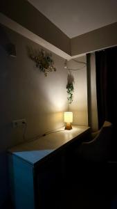 a room with a table with a light on it at Hidden house stay in Mathura +9 photos
