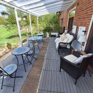 a patio with tables and chairs on a deck at Studio Pachamama in Rotenburg an der Wümme