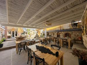 a patio with tables and chairs and a fireplace at Filizce Alaçatı in İzmir