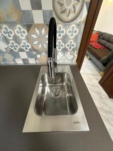 a kitchen sink with a faucet on a counter at Casa Alba in Chioggia +13 photos