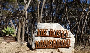 a sign on a rock that reads the rusty monarchy at The Rusty Kangaroo Hideaway - Ocean-View - Full Booking Service, Ferry, Experiences, Tour Option in Penneshaw