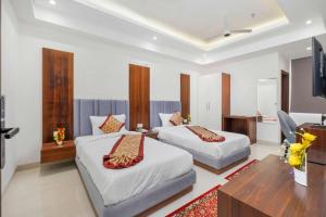 a hotel room with two beds and a television at Hotel The Balram in Ayodhya +35 photos