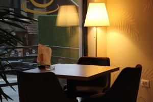 a conference room with a table and chairs and a lamp at Palas rooms in Smederevska Palanka
