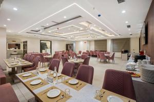 a restaurant with tables and chairs in a room at Hotel The Balram in Ayodhya