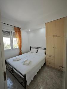 a bedroom with a bed with two towels on it at SeaSummerSand Apartment in Chios