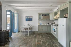 a kitchen with green cabinets and a table in it at Almira 2 in Livadakia +6 photos