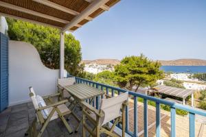 a balcony with a table and chairs and a view of the ocean at Almira 2 in Livadakia
