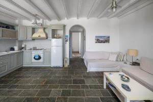 a living room with a couch and a kitchen at Almira 2 in Livadakia