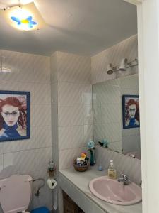 a bathroom with a sink and a toilet and a mirror at Apartamento de las Buganvillas in Vera +31 photos