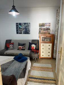 a living room with a couch and a dresser at Apartamento de las Buganvillas in Vera