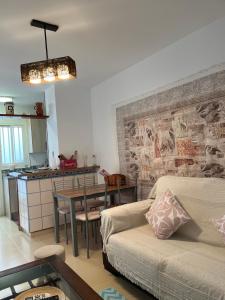 a living room with a couch and a table at Apartamento de las Buganvillas in Vera