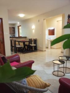 a living room with a table and chairs at MAIDA Apartment - SHAWMUT SUITES in Nakuru