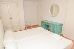 a room with two beds and a blue table at Home D'or in Cala d´Or +18 photos