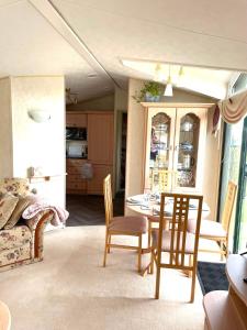 a dining room with a table and chairs at Sun rise in Macclesfield