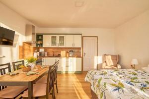 a kitchen and dining room with a table and a bed at Villa Harmony in Český Krumlov