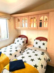 a small room with two beds with black stars at Sun rise in Macclesfield