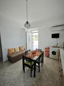 a living room with a table and a couch at SeaSummerSand Apartment in Chios +14 photos