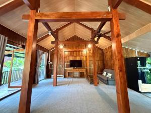 a living room with wooden walls and a wooden ceiling at New Sunshine Homestay in Hoi An