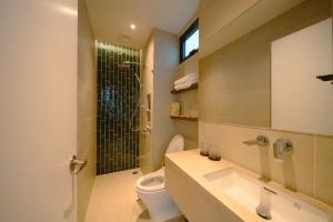 a bathroom with a toilet and a sink and a shower at ANNA Boutique Villa - Sea View in Phan Thiet