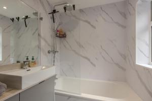 a white bathroom with a sink and a shower at High End Central Location 2 Bedroom in Stoke on Trent +24 photos