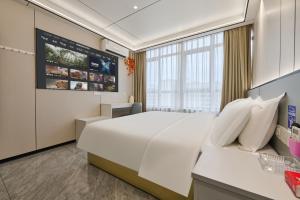 a bedroom with a large bed and a large window at Four Seasons Clouds Xiamen North Railway Station Store in Xiamen