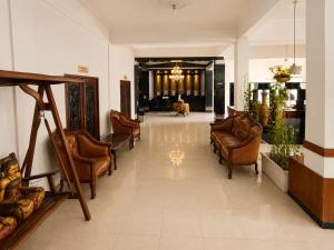 a lobby with couches and chairs in a building at Satya Graha Hotel Yogyakarta in Yogyakarta +49 photos